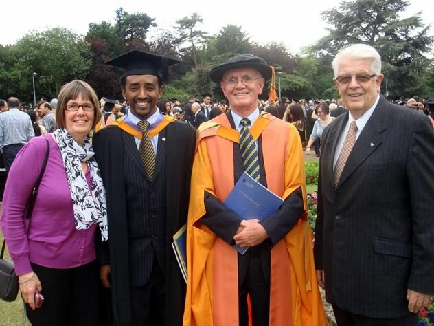 Ysakor Hailu gets his MBA (Merit) from DeMontfort University Leicester - Jul 11, with supporter ex-Trustee Liz Martin, A-CET CEO David & Patron Dr Michael Burden